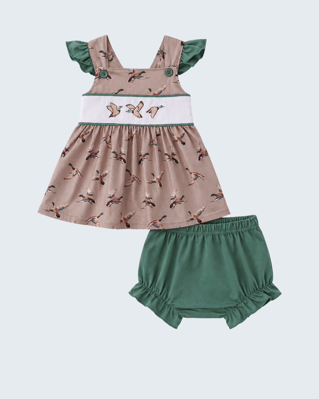 Children's dress with duck pattern and green bloomers on a light blue background