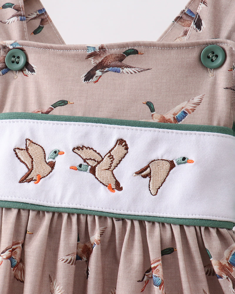 Close-up of a fabric with duck pattern and embroidered band