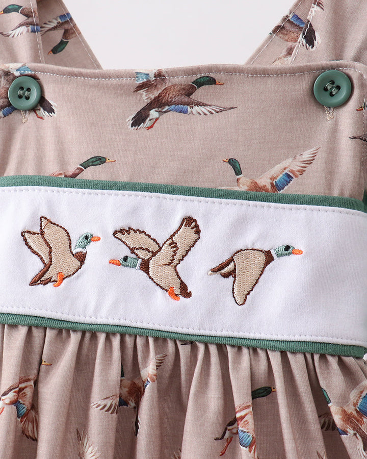 Close-up of a fabric with duck pattern and embroidered band