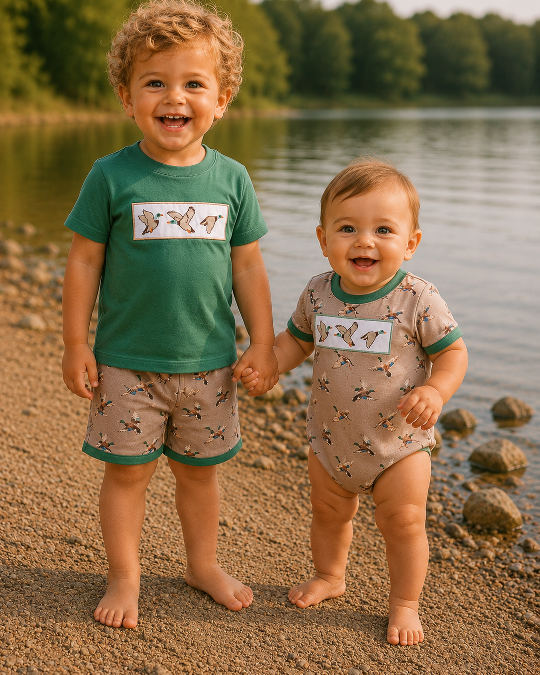 Two children holding hands on a beach with a lake in the background