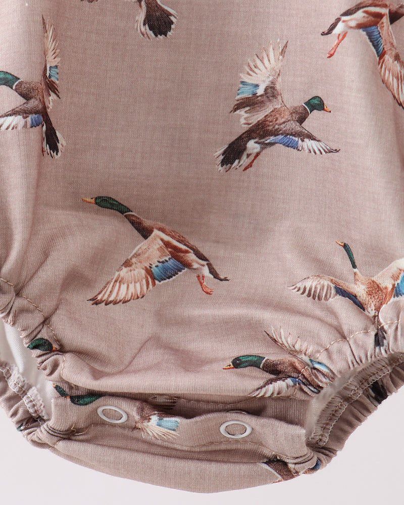 Fabric with duck pattern on a beige background