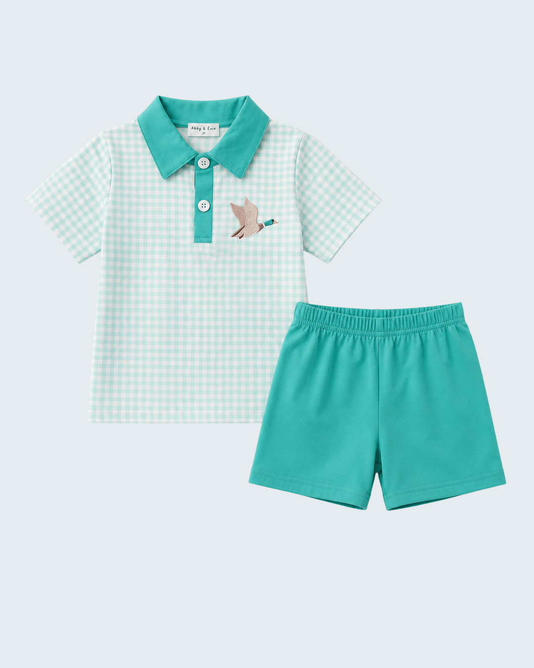 Children's teal checkered shirt and shorts set on a light blue background