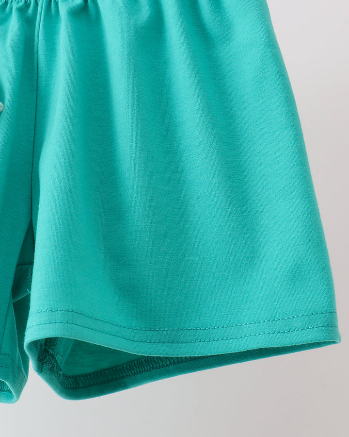 Close-up of teal shorts on a light gray background