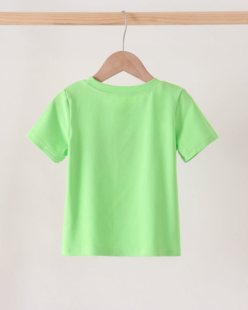A bright lime green short-sleeve t-shirt hanging on a wooden hanger from a light wood clothing rack against a plain off-white background.