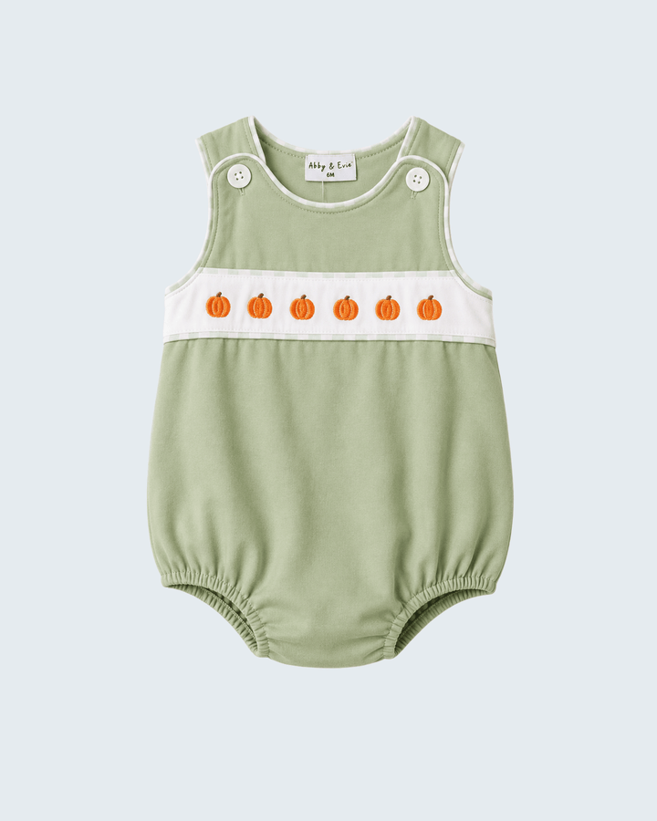 A sage green sleeveless baby romper with a white chest band featuring embroidered orange pumpkins, shown on a light gray background.