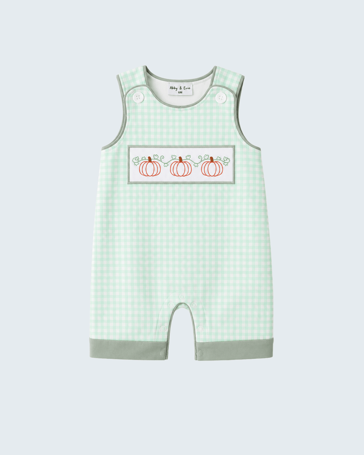 A baby sleeveless romper in a light green and white gingham pattern, featuring a chest patch with three embroidered orange pumpkins and the text &