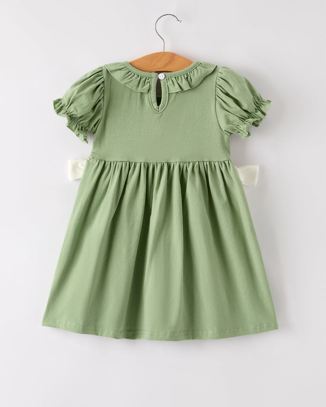 Green embroidered smock dress with gathered neckline and short puff sleeves.