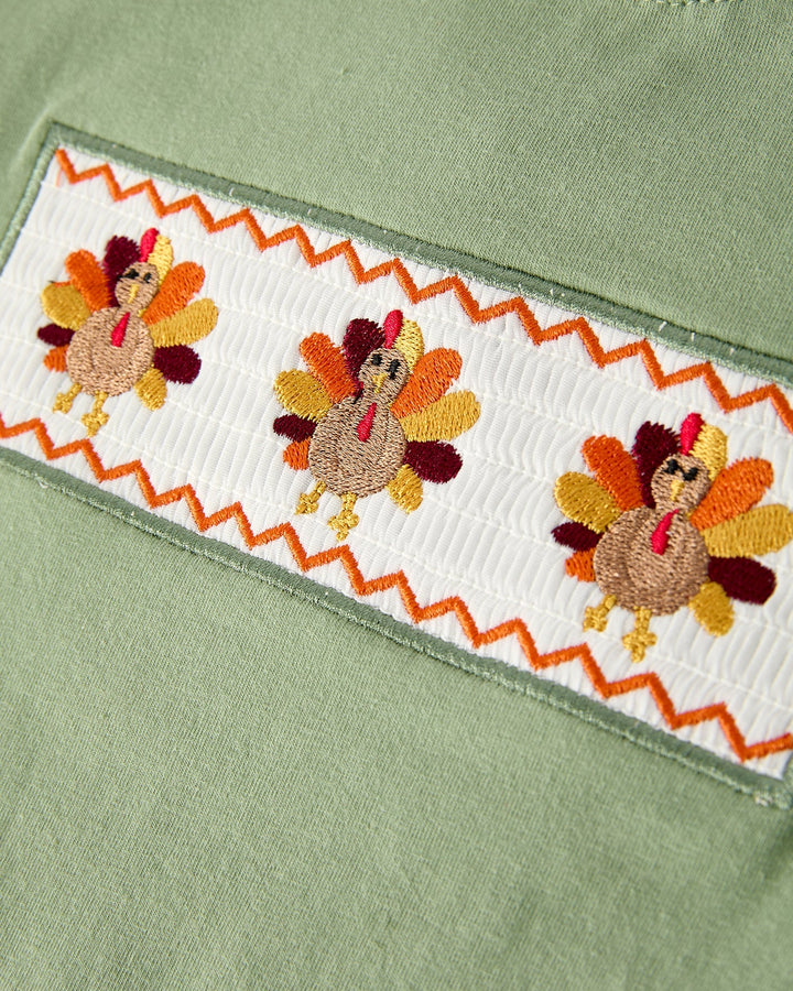 Green shirt trim with white band and embroidered turkey motifs