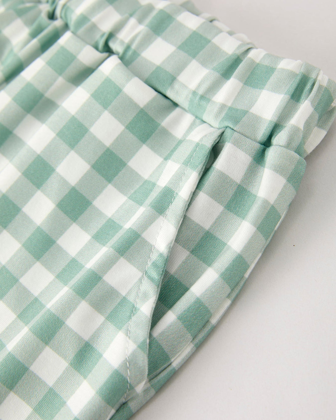 Green gingham plaid pants with gathered waistband and stitched seam detail