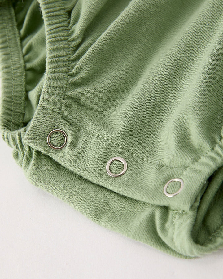 Green romper with snap buttons at the leg opening