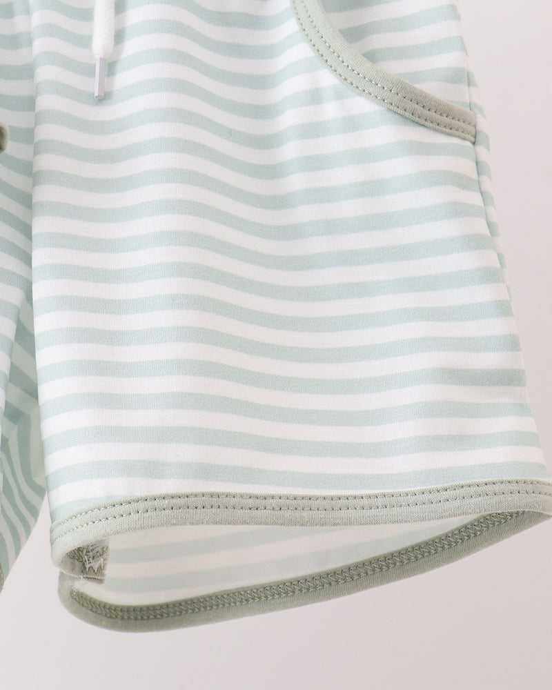 Striped outfit with a zipper on a light gray background