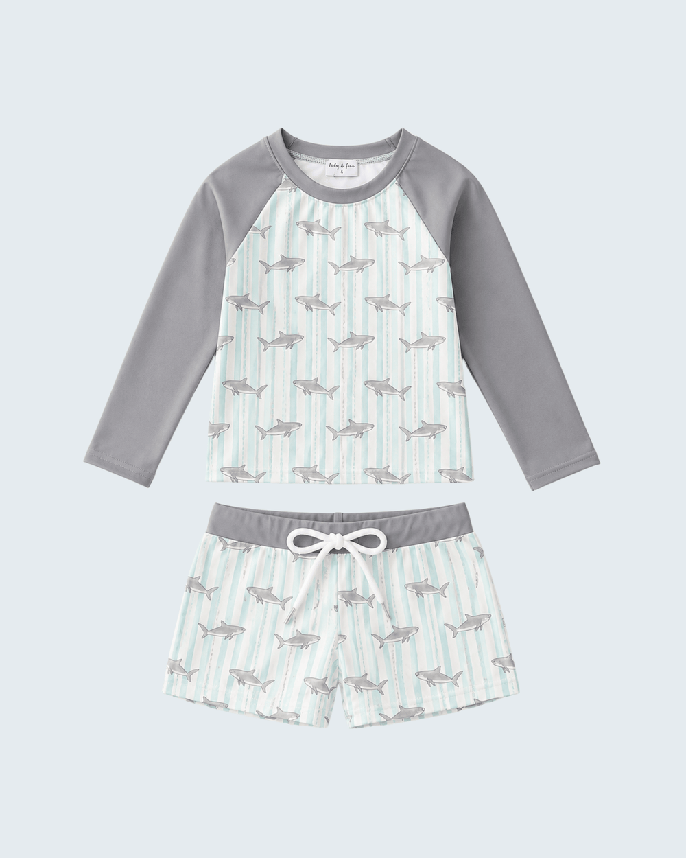 Children's swim set with shark pattern on a light gray background