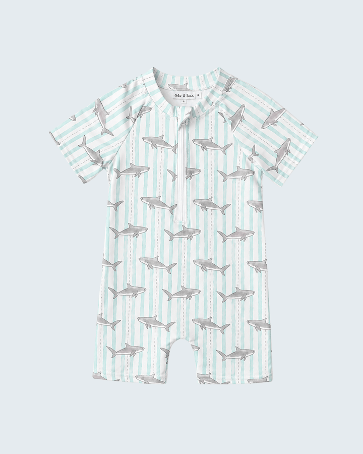 Baby swimsuit with shark pattern on a light blue background