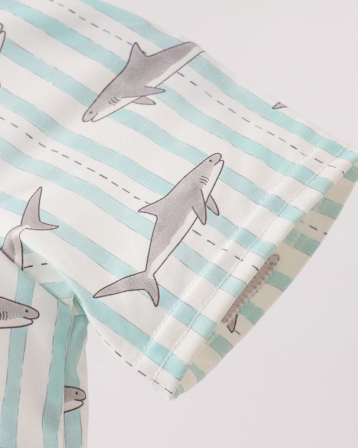 Fabric with shark pattern and light blue stripes on a white background