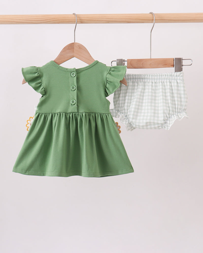 Green short-sleeve baby dress with front buttons and sunflower hem detail