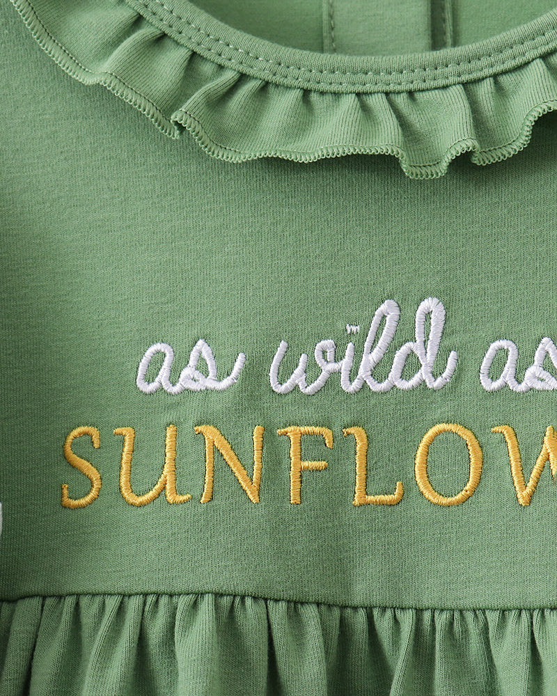 Green ruffle baby dress top with embroidered text and scalloped collar