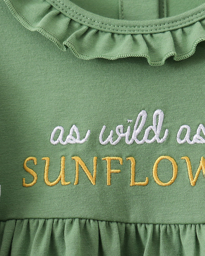 Green ruffle baby dress top with embroidered text and scalloped collar