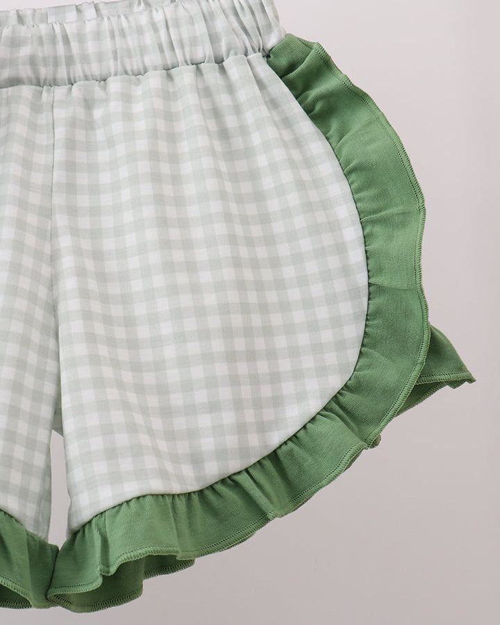 Gingham check shorts with green ruffle trim and elastic waistband