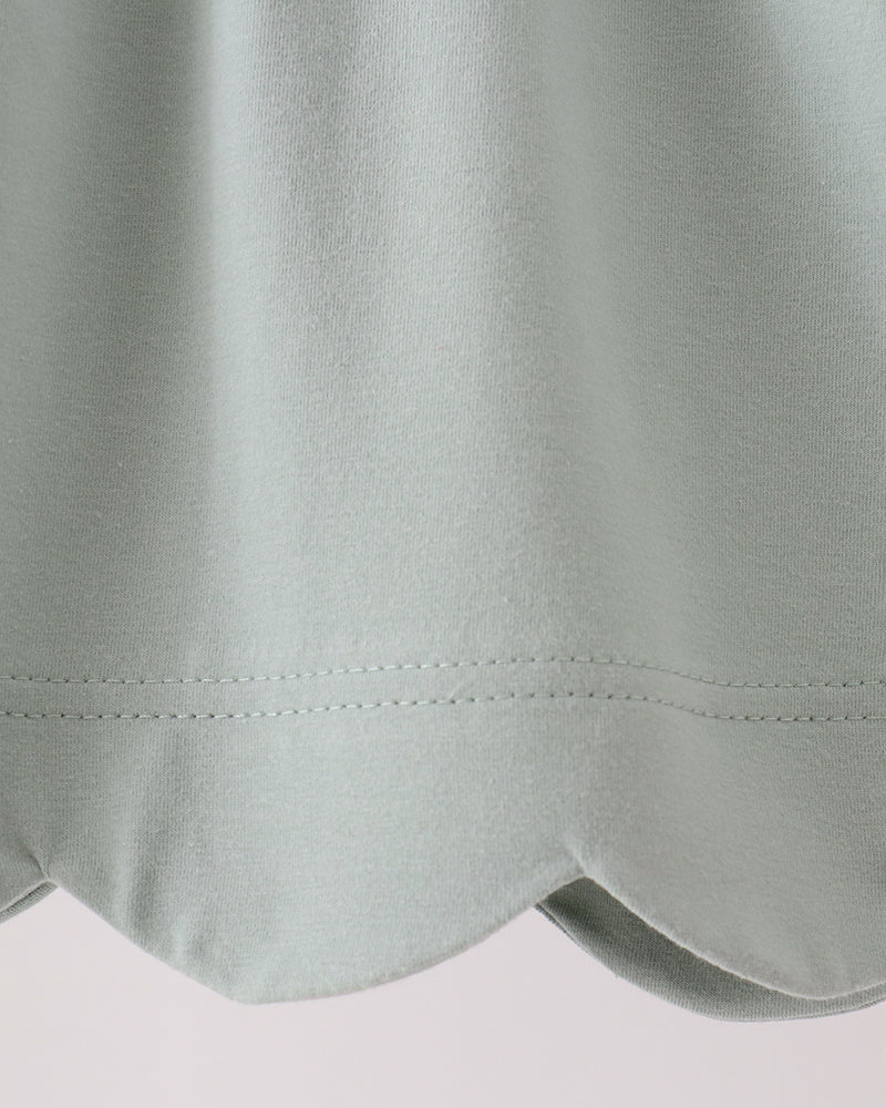 Sage green dress with scalloped hem and stitched seam detail
