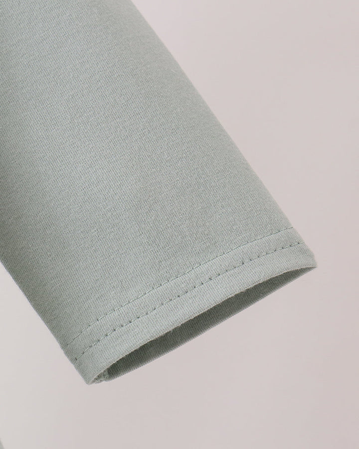 Sage green long-sleeve cuff with stitched hem edge