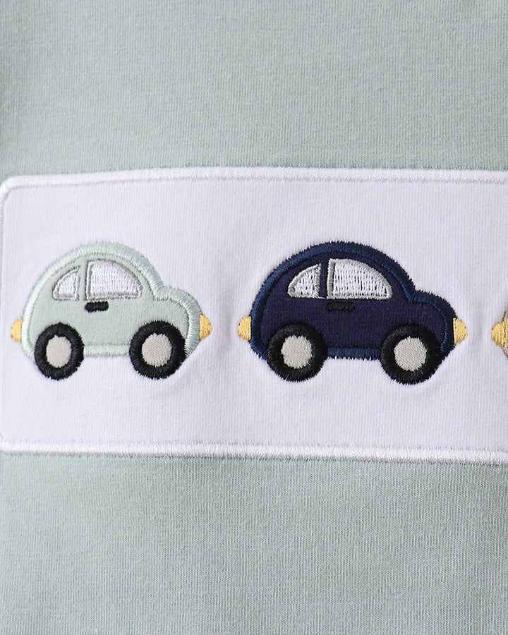 Light blue fabric with embroidered cars on a white border