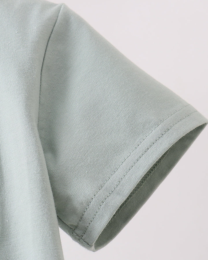 Close-up of a light gray fabric sleeve on a plain background