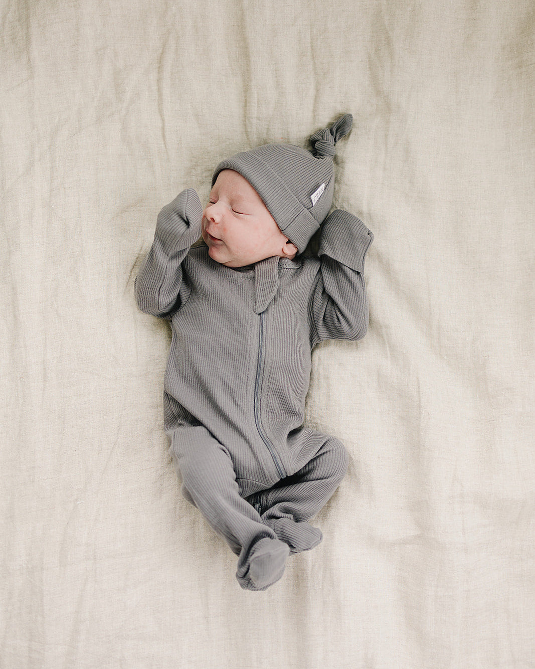 Grey ribbed cotton zipper romper on baby, hooded zip-front suit