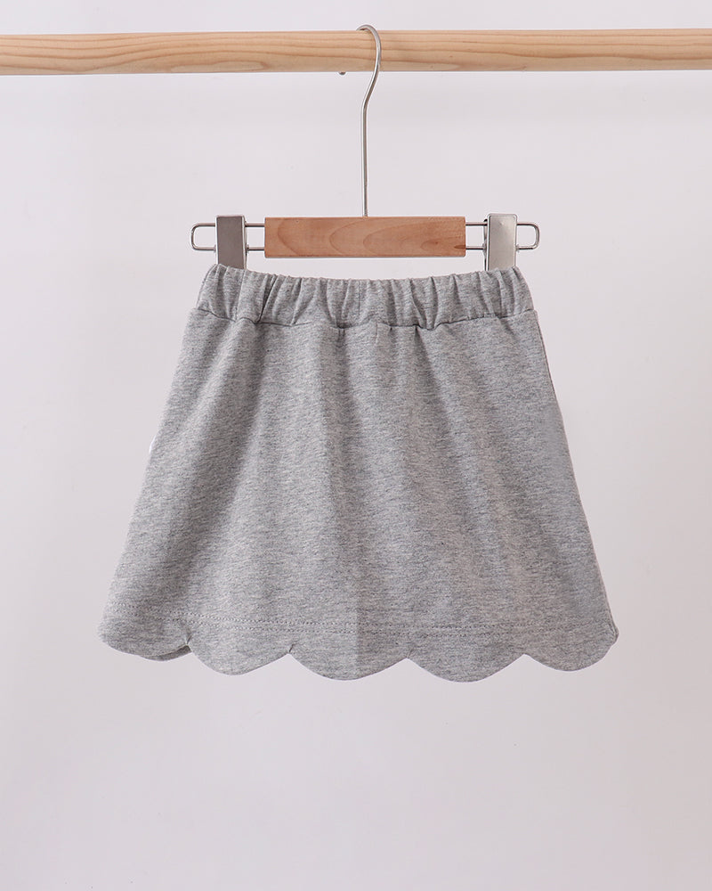Grey skort with elastic waist and scalloped hem, white bow accent