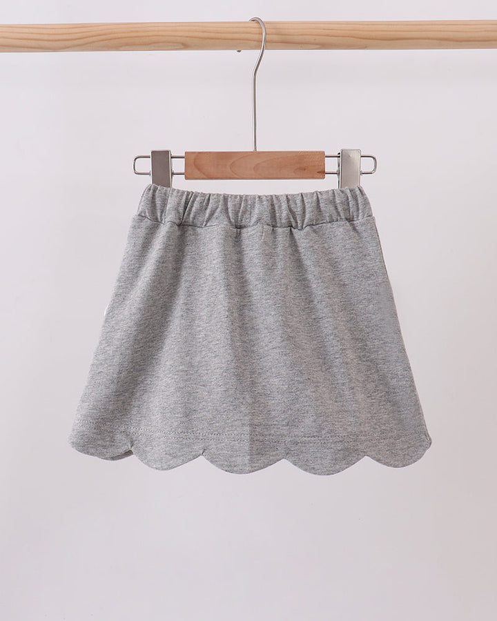 Grey skort with elastic waist and scalloped hem, white bow accent
