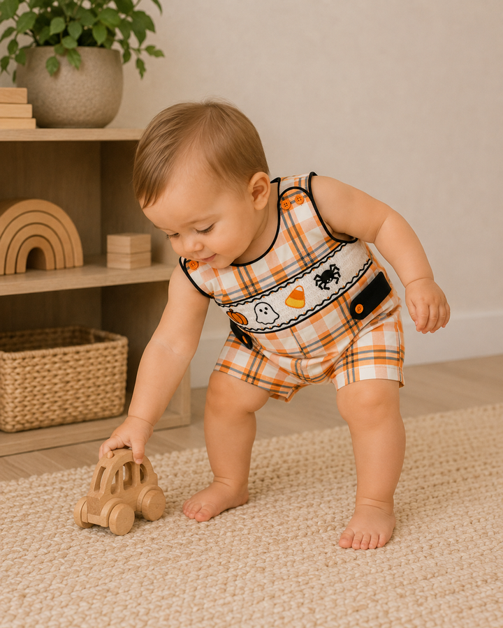 Orange plaid jon jon romper, worn by toddler, with black trim and Halloween prints