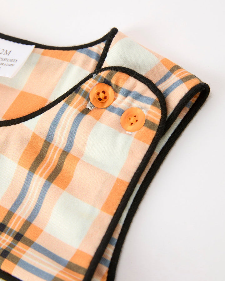 Plaid JonJon romper neckline with two orange buttons and black trim