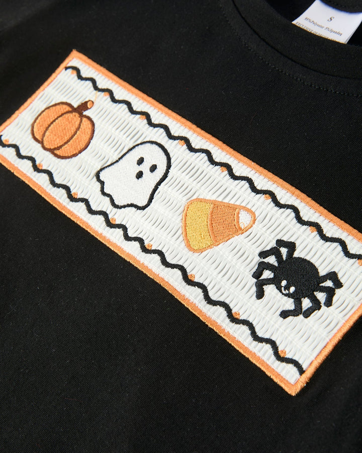 Black graphic T-shirt panel with stitched Halloween characters patch