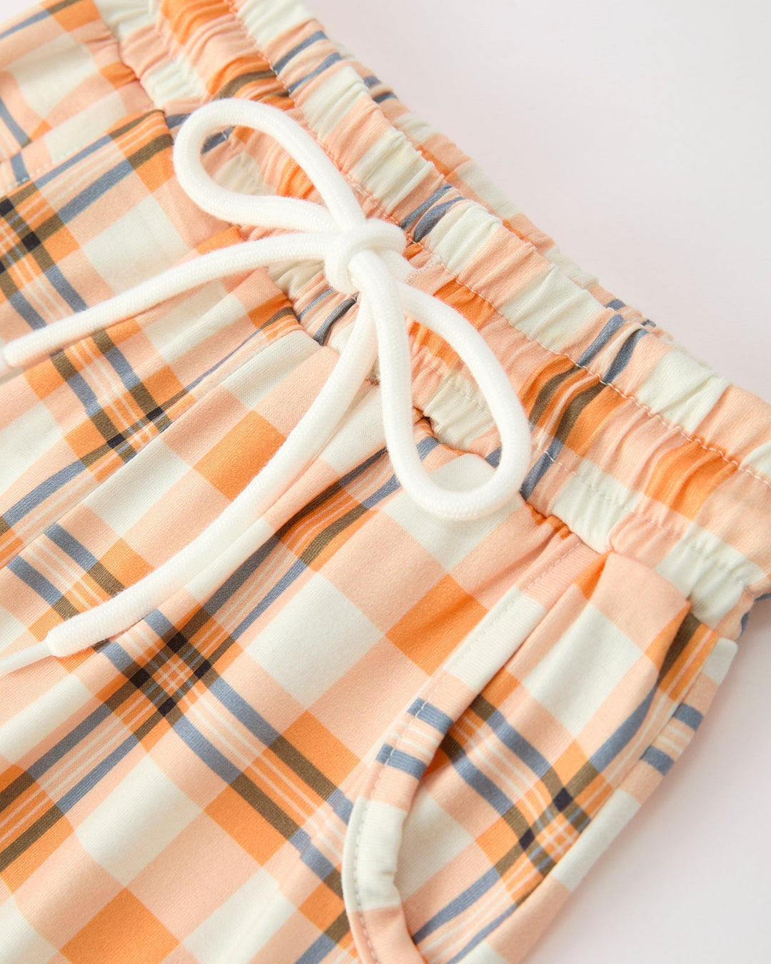 Orange plaid boys pajama pants with elastic waist and white drawstring tie