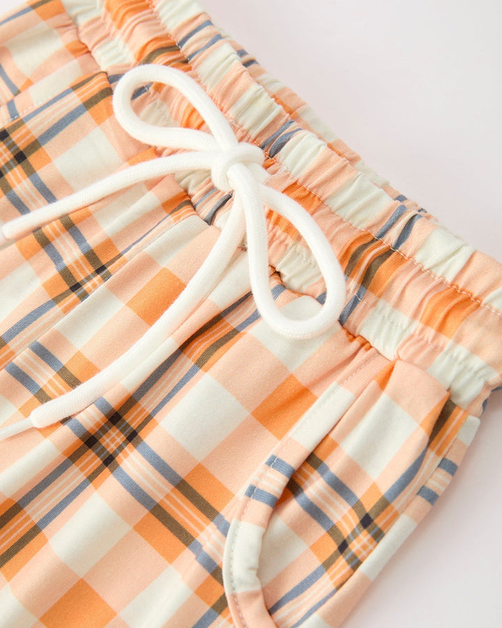 Orange plaid boys pajama pants with elastic waist and white drawstring tie