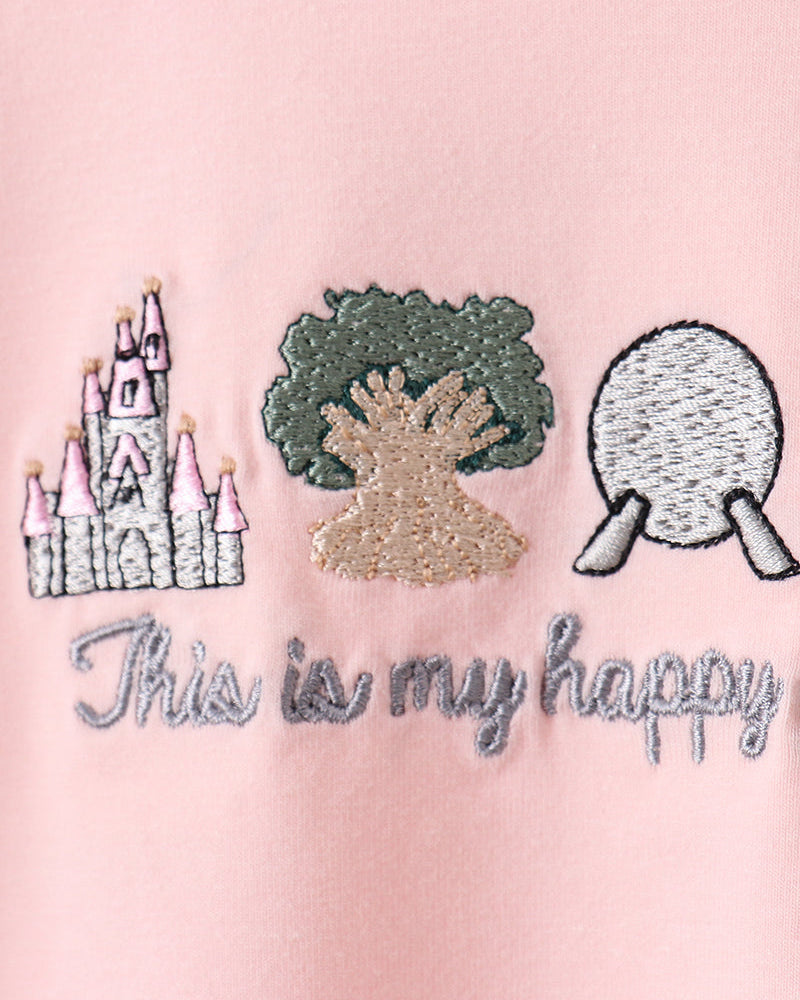 Pink shirt with embroidered designs and text on a pink background