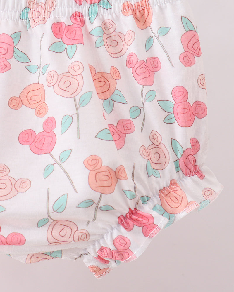 Floral patterned shorts with pink flowers on a light background