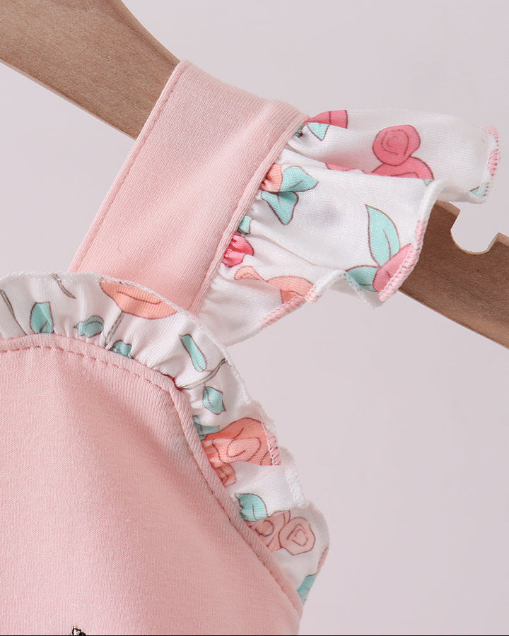 Close-up of pink fabric with floral pattern on a white background