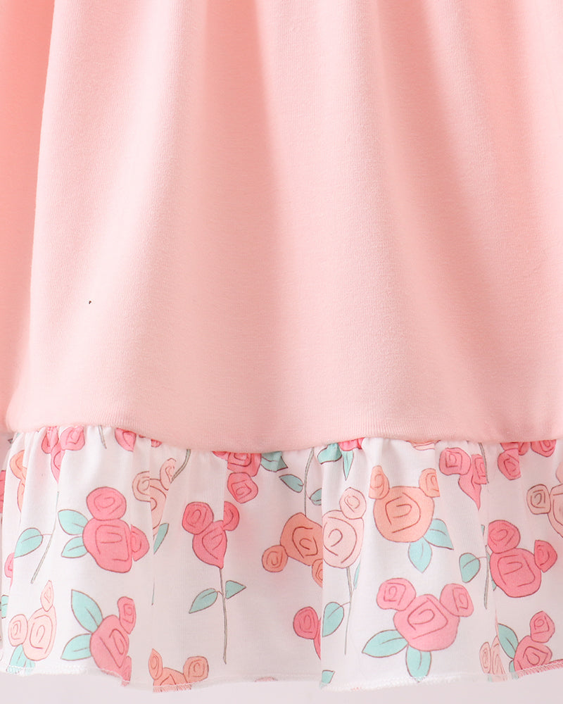 Pink fabric with floral patterned trim on a white background