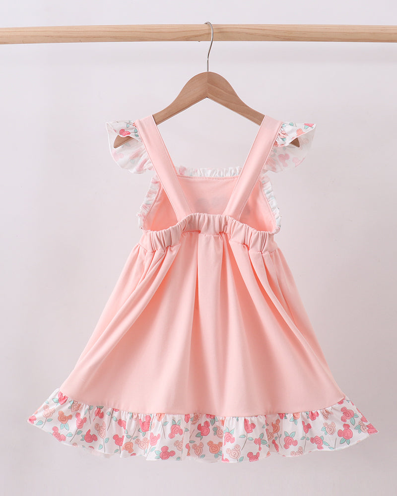 Pink pinafore-style dress with flutter ruffled sleeves and layered skirt