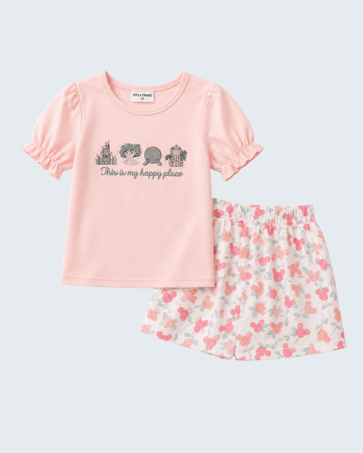 Pink t-shirt with text and floral skirt on a light gray background