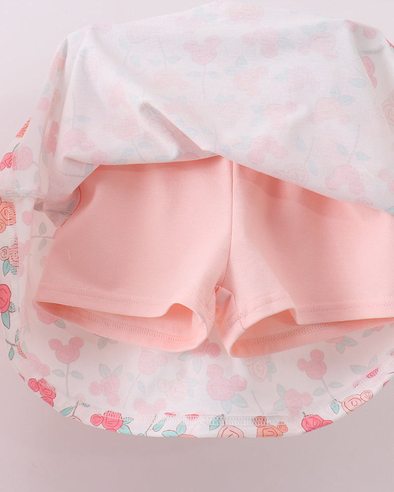 Pink shorts with a floral patterned fabric on a light pink background