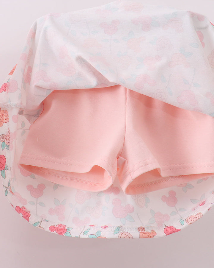 Pink shorts with a floral patterned fabric on a light pink background