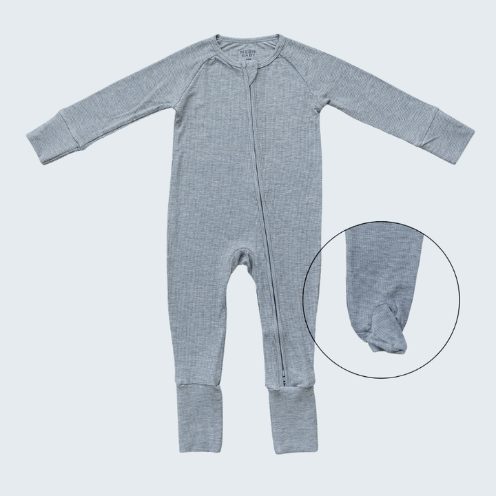 Gray baby onesie with a close-up of the foot area on a light gray background