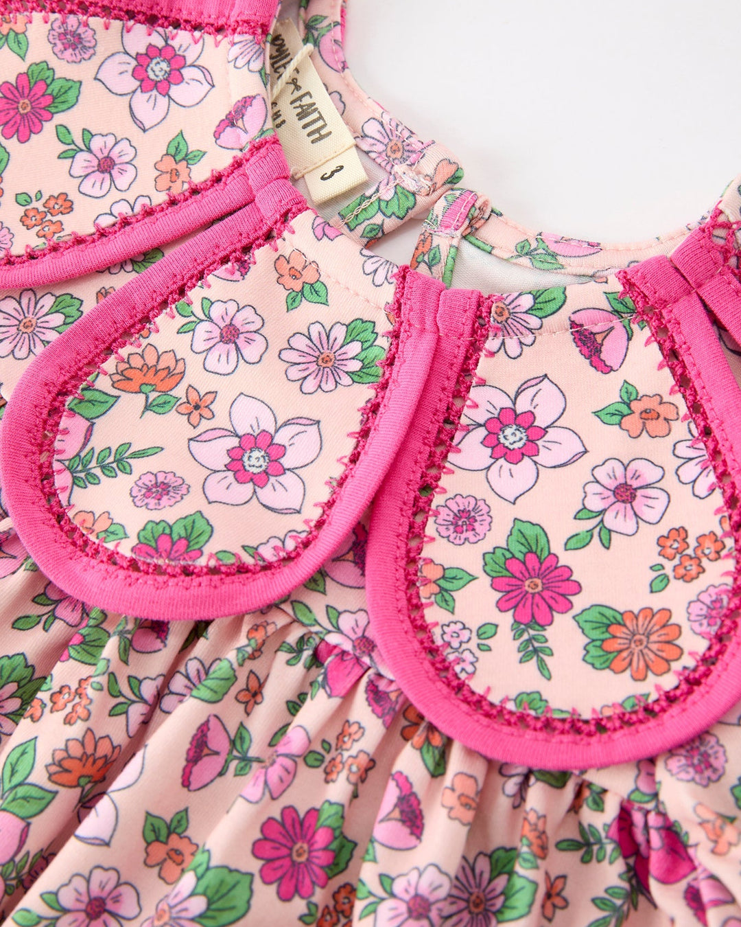 Floral girl dress bodice with hot pink petal-style collar trim