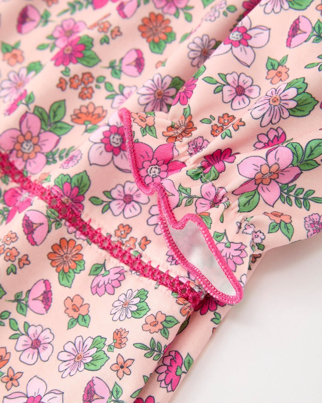 Floral girl dress with hot pink ruffled trim and gathered yoke seams
