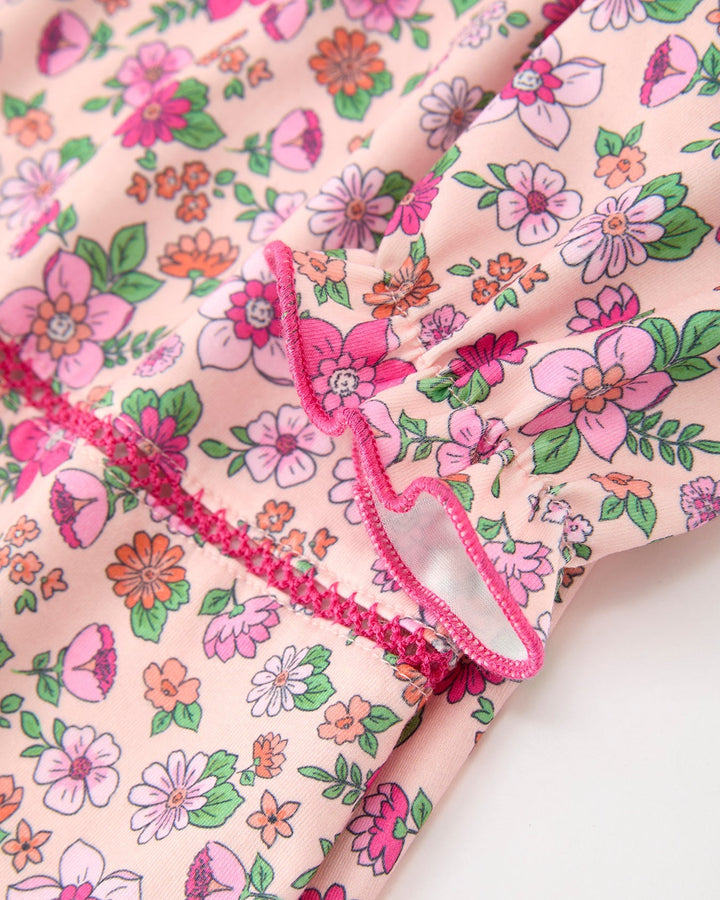 Floral girl dress with hot pink ruffled trim and gathered yoke seams