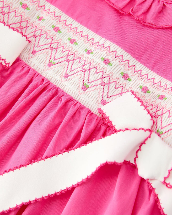 Girls hot pink dress with zigzag white embroidery across the yoke