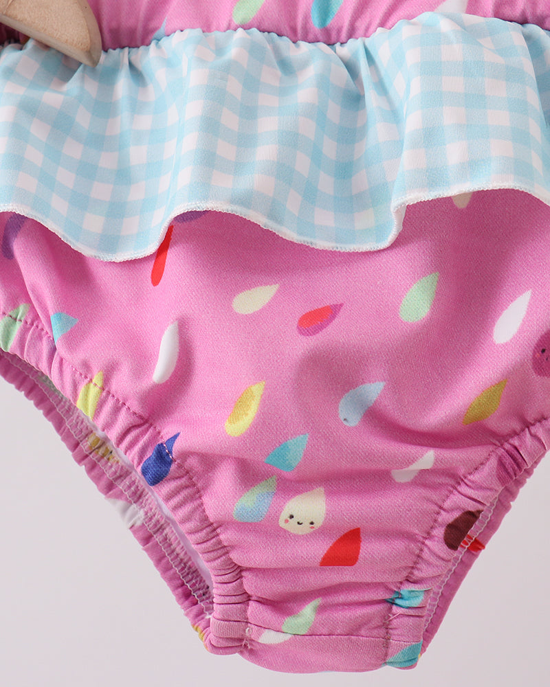Swim bottoms with colorful cloud pattern on a light gray background