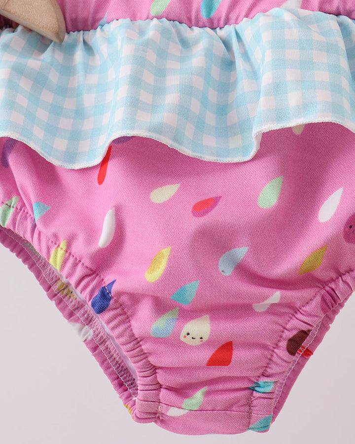 Swim bottoms with colorful cloud pattern on a light gray background
