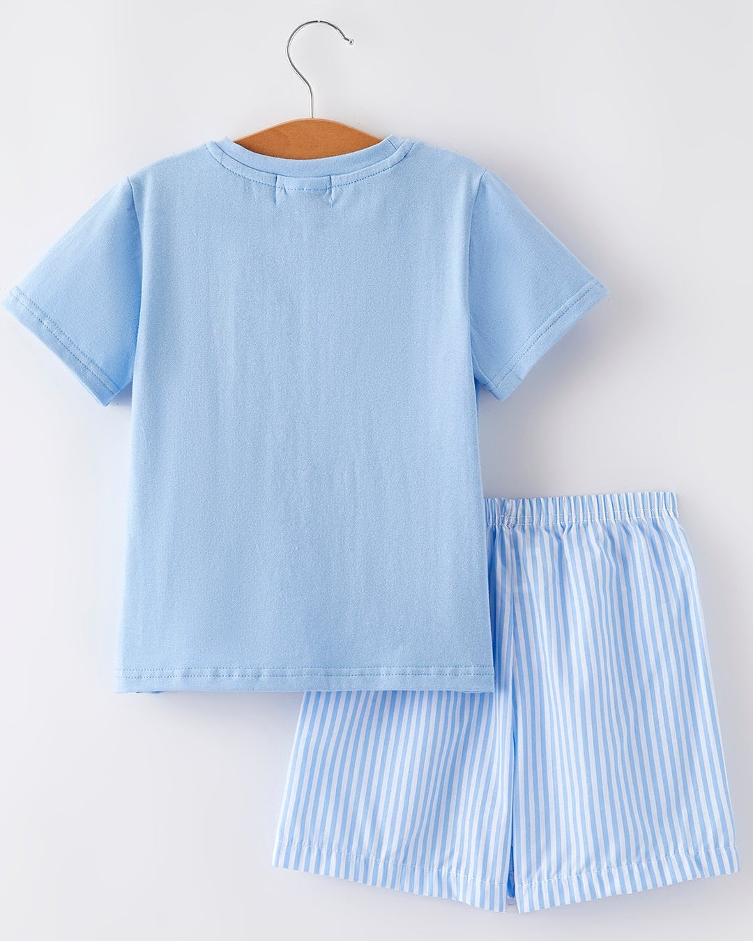 Light blue shorts set with matching shorts on a hanger against a white background